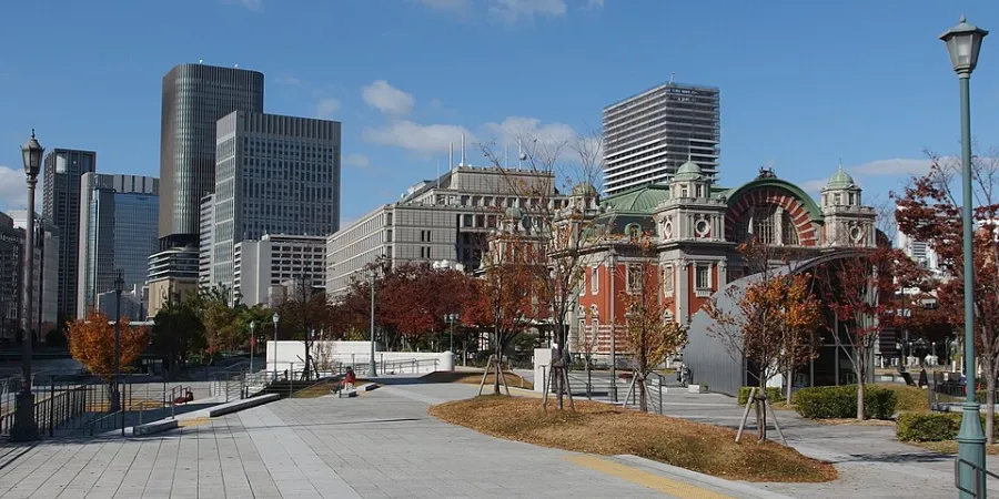 Nakanoshima Park in central Osaka with autumn trees, modern skyscrapers and the historic Osaka City Central Public Hall