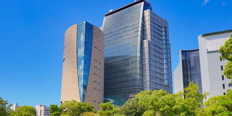 NHK Osaka Broadcasting Center and surrounding modern buildings viewed from a green park in Osaka, Japan