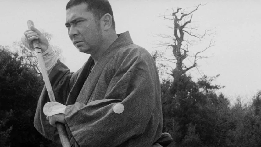 Shintaro Katsu as the blind masseur Ichi, holding his cane sword upright, in Kenji Misumi's The Tale of Zatoichi.