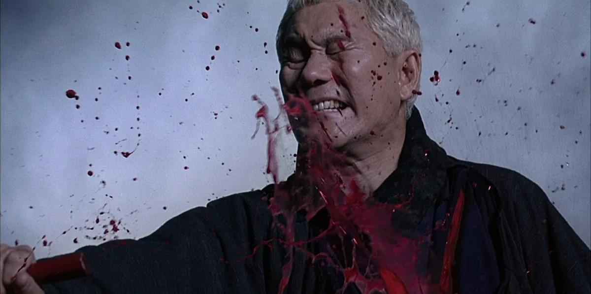 A swordsman cut down in Takeshi Kitano's Zatoichi, showing the film's heavily stylised blood effects.