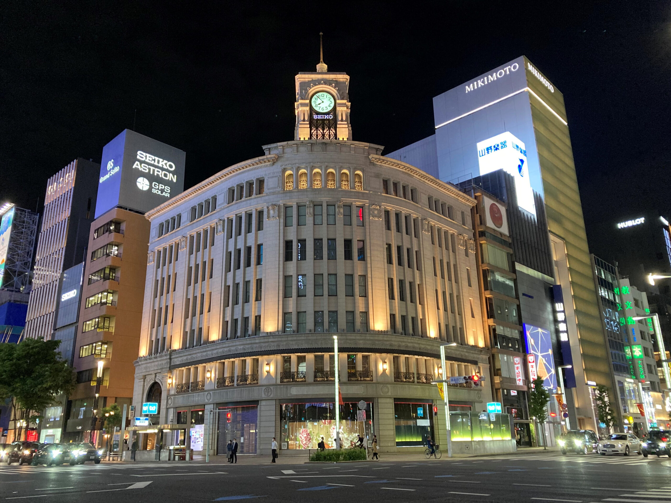 Multi-storey buildings with illuminated signs at the Ginza 4-chome crossing in Tokyo at night