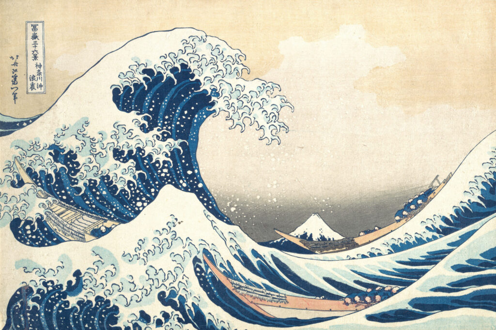 Hokusai's Under the Wave off Kanagawa, the ukiyo-e woodblock print of a towering blue wave curling over three fishing boats with Mount Fuji small on the horizon, the centrepiece of Beneath the Great Wave at the Whitworth, Manchester