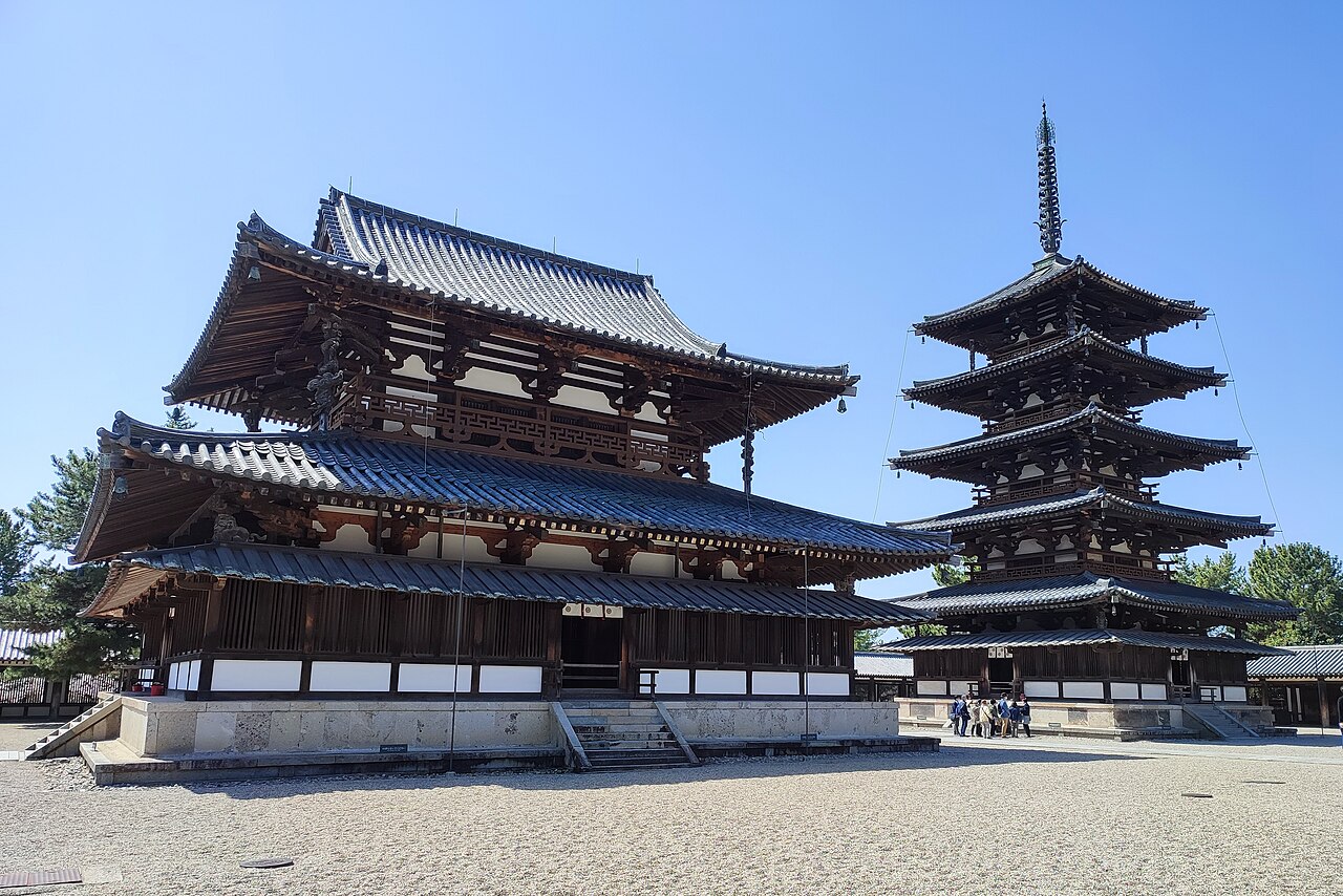 The two-storey Main Hall and the five-storey pagoda standing side by side in Horyu-ji's Western Precinct under a blue sky