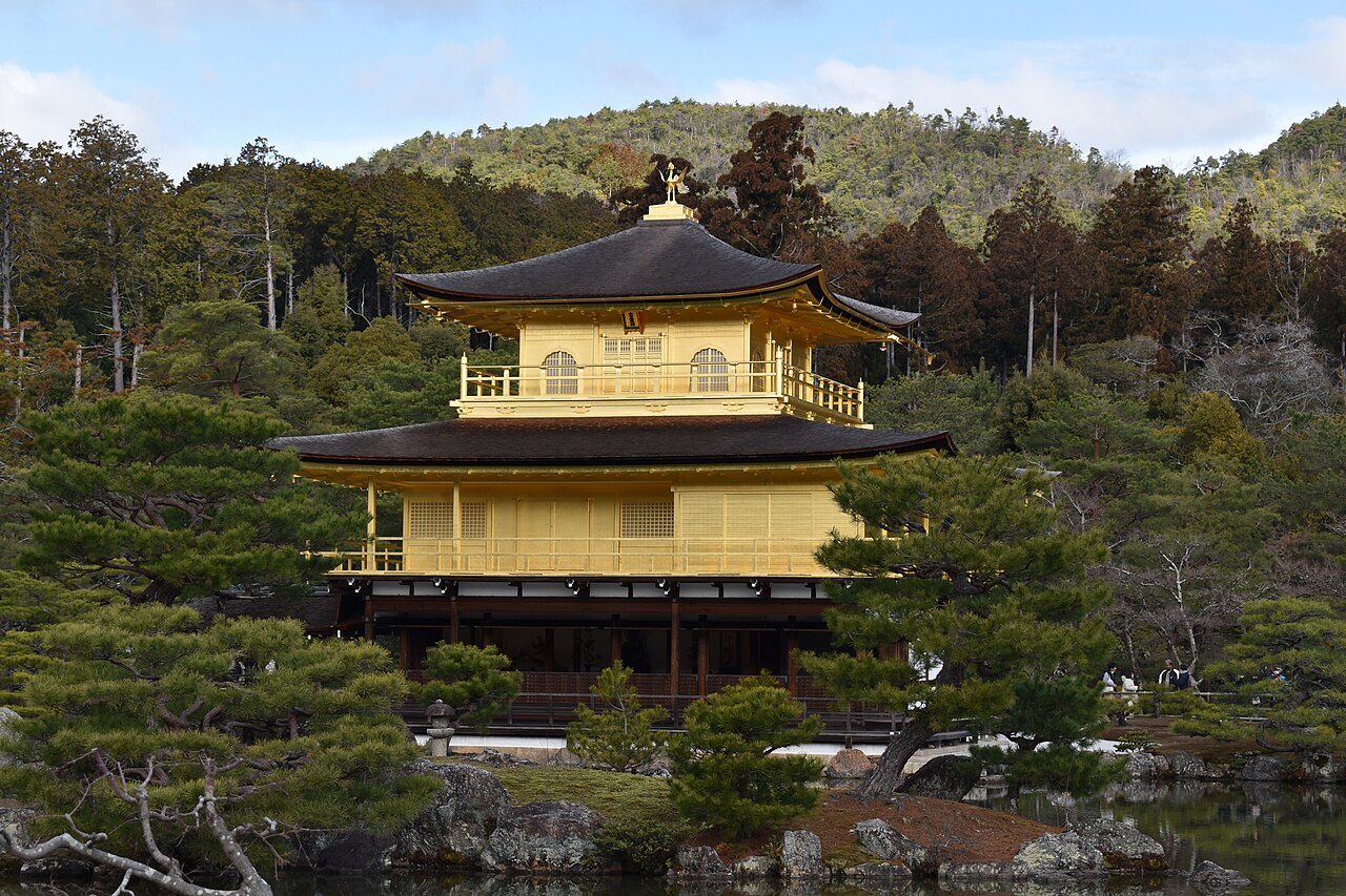 Kinkaku-ji, the gold-leafed Golden Pavilion, beside its pond with wooded hills behind