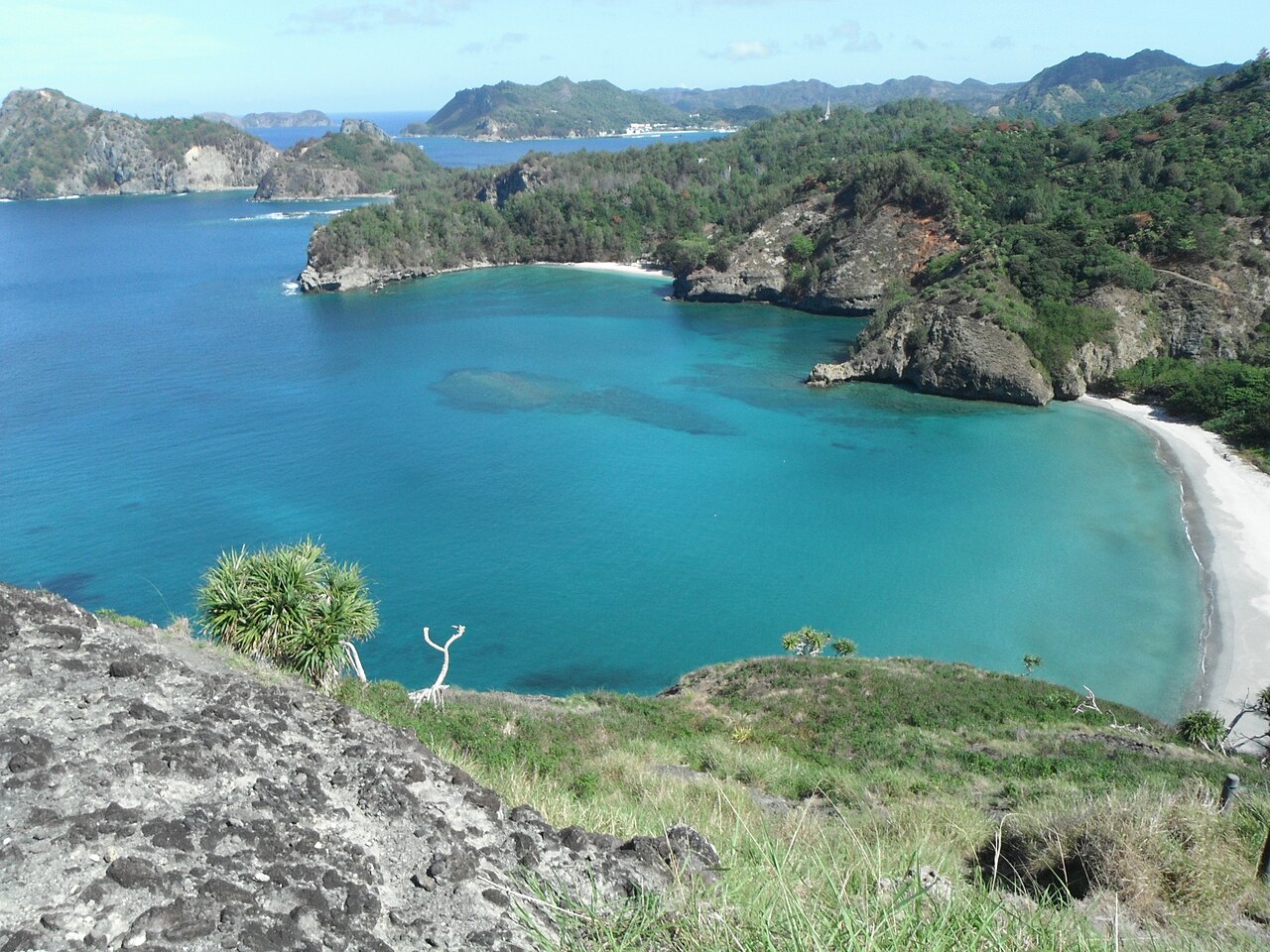 Turquoise water and a white-sand cove at Kominato Beach on Chichijima, seen from the Nakayama Pass, Ogasawara Islands