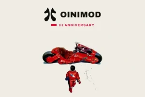 Kaenda, a character from Akira in a red outfit walks towards the iconic futuristic red motorcycle, beneath the OINIMOD III Anniversary logo.