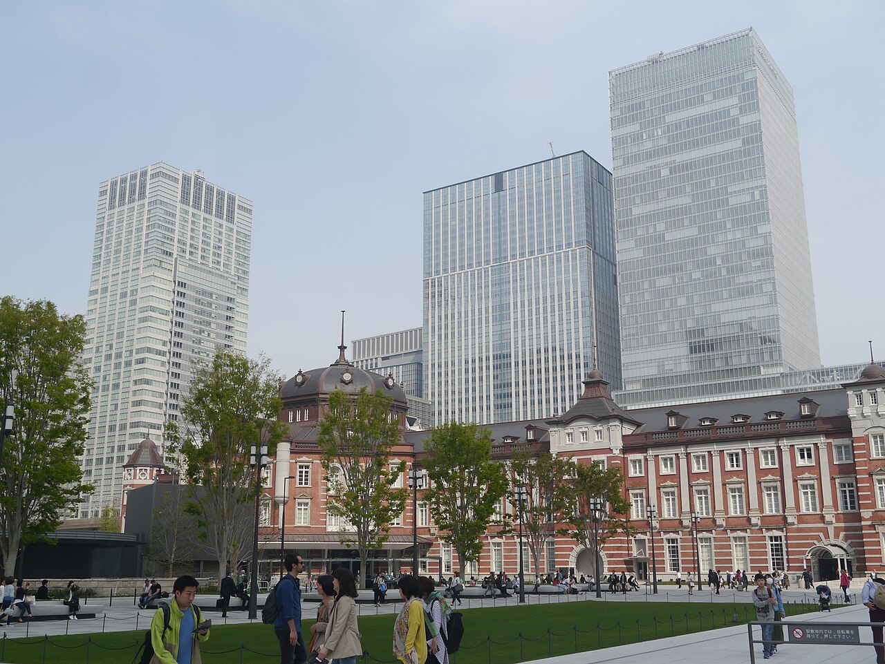 The red brick Marunouchi building of Tokyo Station with office towers behind it