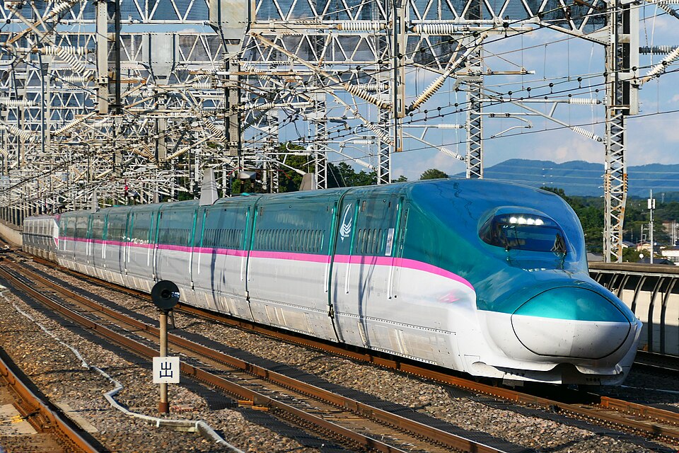Green and white E5 series Hayabusa Shinkansen running on the Tohoku Shinkansen line