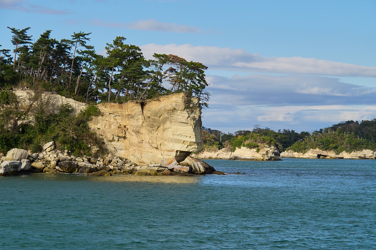 A pine-topped rocky island in the calm blue water of Matsushima Bay, Miyagi Prefecture