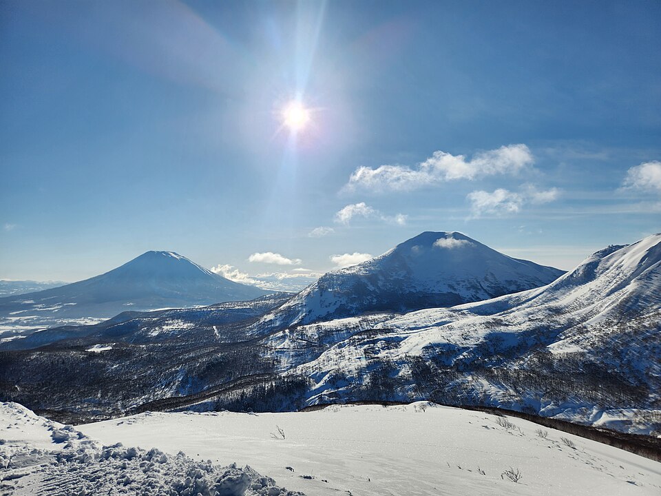 Snow covered Mount Yotei and Mount Niseko Annupuri under a bright winter sun in Niseko, Hokkaido