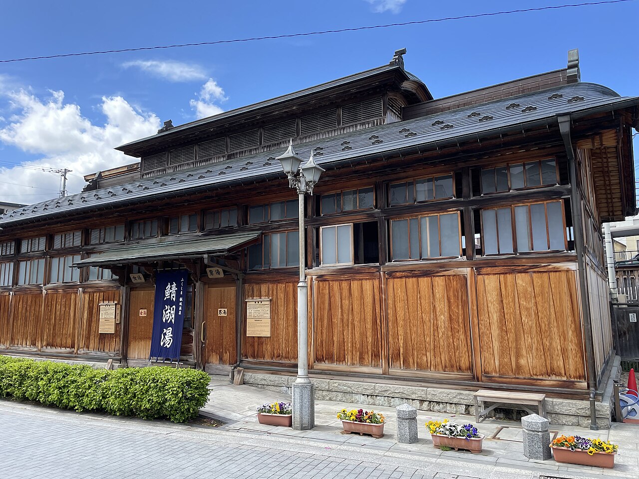 The wooden Sabako-yu public bathhouse on a street in Iizaka Onsen, Fukushima