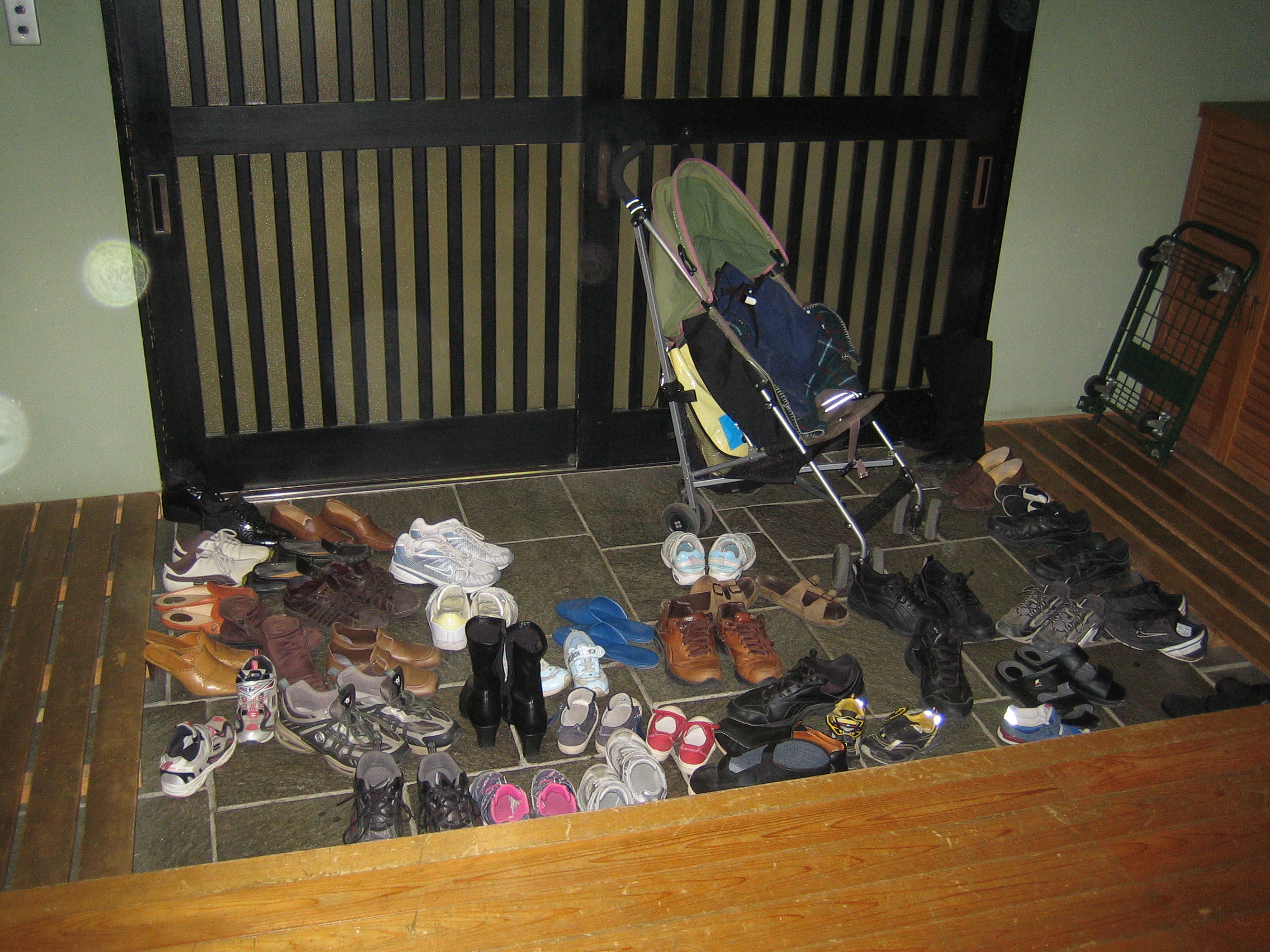 Shoes left in the genkan entrance of a Japanese home before stepping up into the house