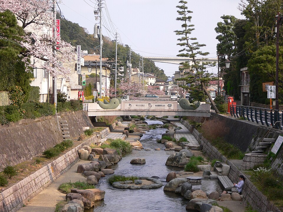 The Tamayu River running through Tamatsukuri Onsen in Matsue, lined with cherry trees in blossom