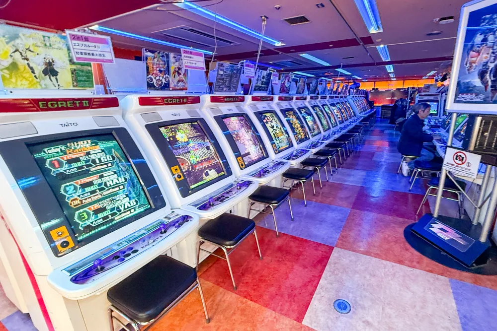 A long row of Taito Egret II arcade cabinets in an Akihabara game centre