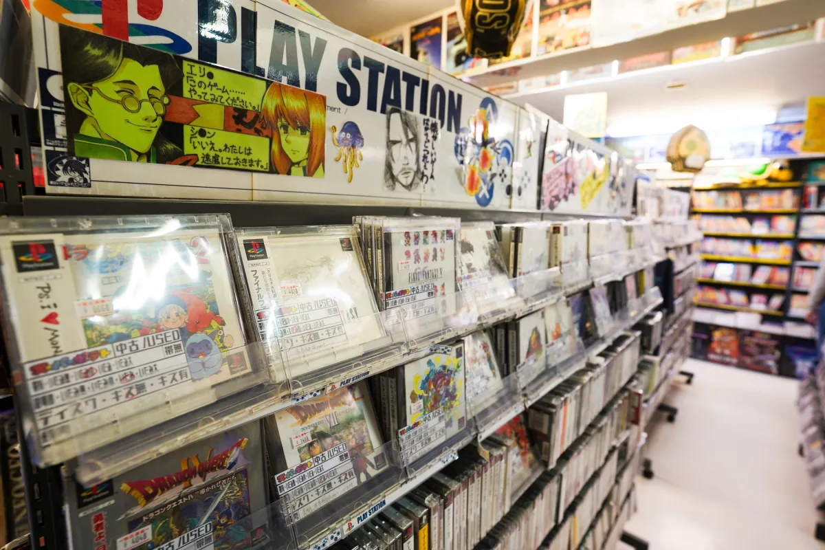 Shelves of used PlayStation games in an Akihabara retro game shop