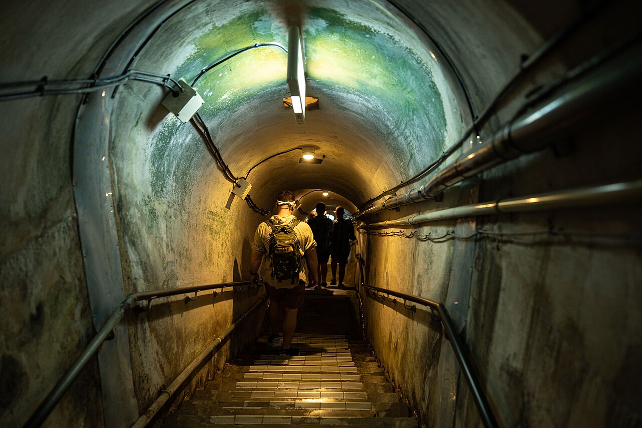 US Marines walking through a tunnel during a guided tour of Battle of Okinawa sites