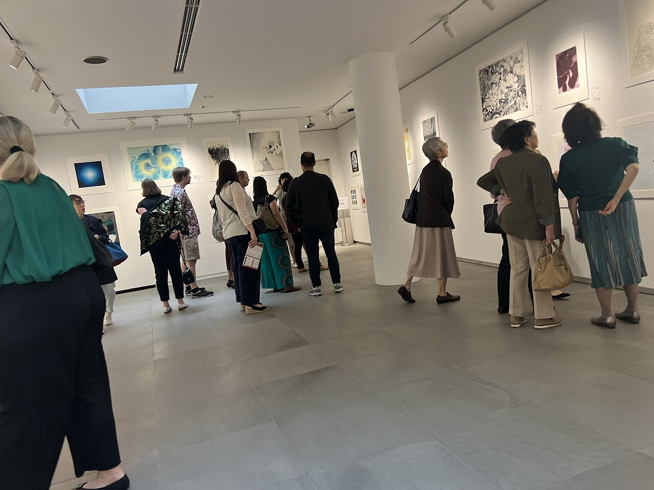 Visitors looking at prints at the CWAJ Print Show in Hillside Forum, Daikanyama