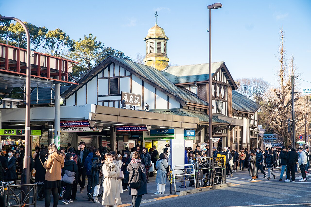 The 1924 wooden Harajuku Station building with its small spire, crowded with people in January 2020