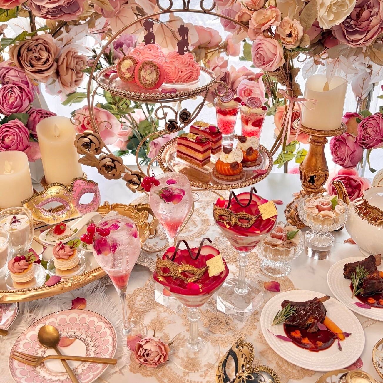 Pink afternoon tea sweets and savouries on a table surrounded by roses at Haute Couture Cafe Nakameguro