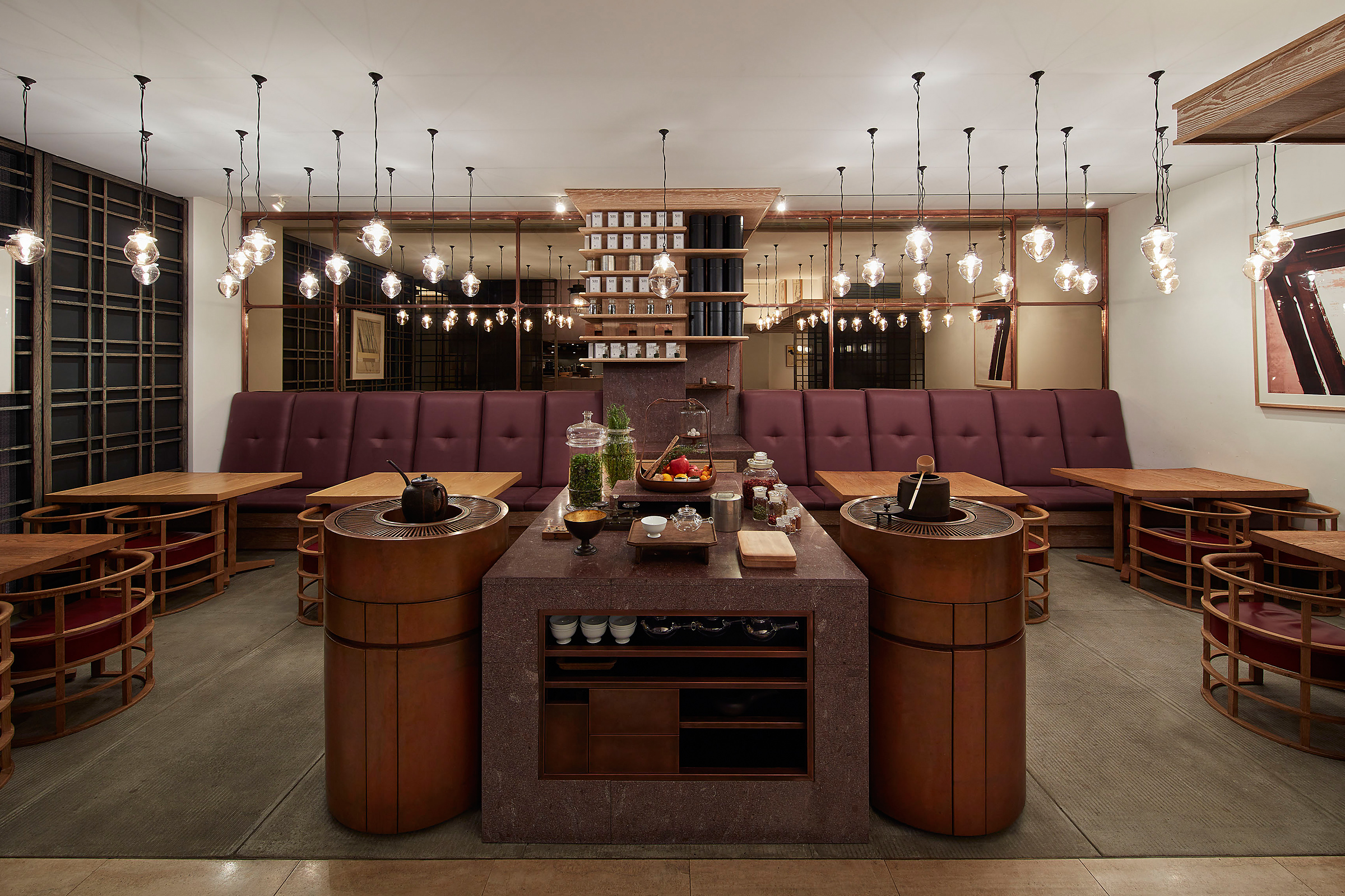 The wood panelled tea salon at Higashiya Ginza with a central counter and banquette seating