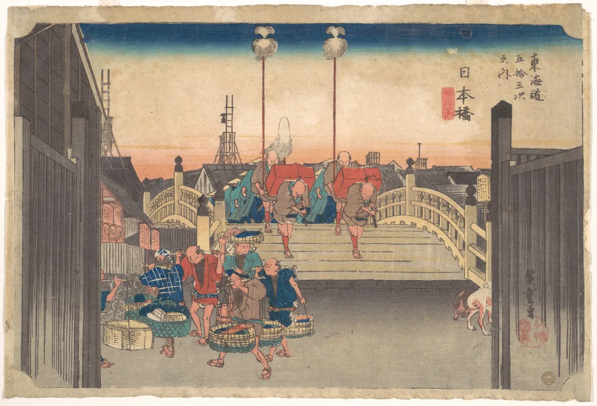 Hiroshige woodblock print of a procession of porters and travellers crossing the wooden Nihonbashi bridge in Edo at dawn, the first image in his Fifty-three Stations of the Tokaido series