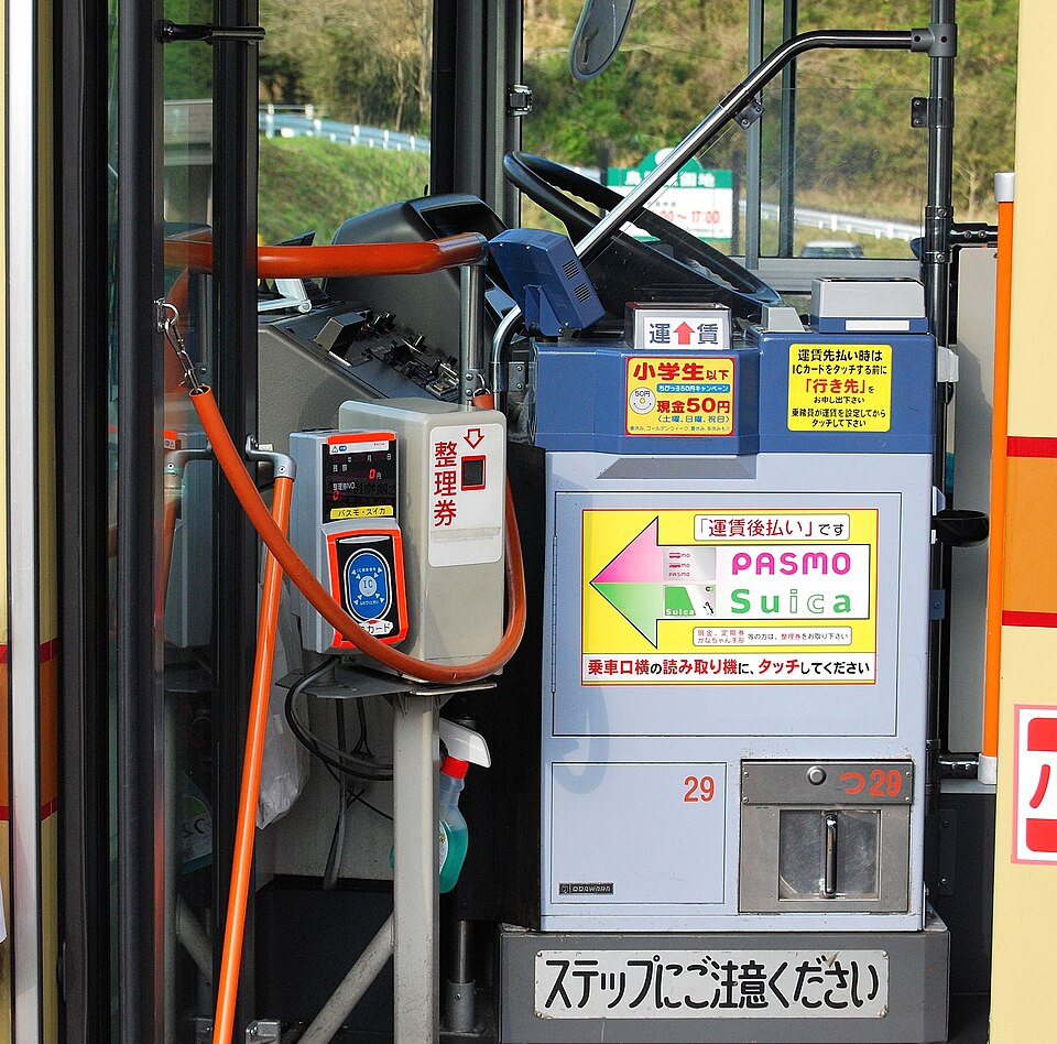 The fare box and PASMO and Suica card reader beside the driver on a Kanachu bus in Kanagawa