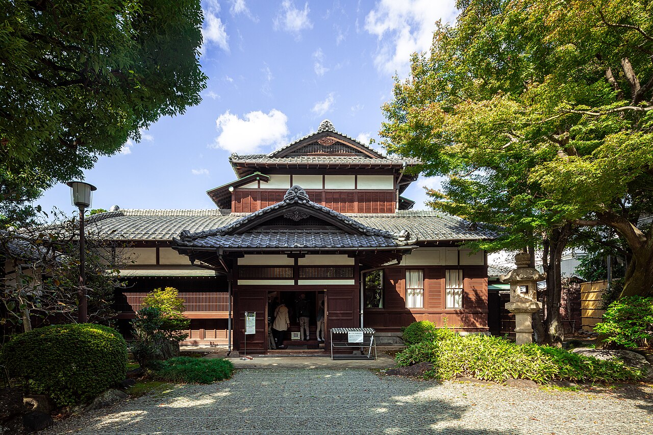 Entrance of Kyu Asakura House, a two storey wooden Taisho era residence with a tiled roof, in Daikanyama