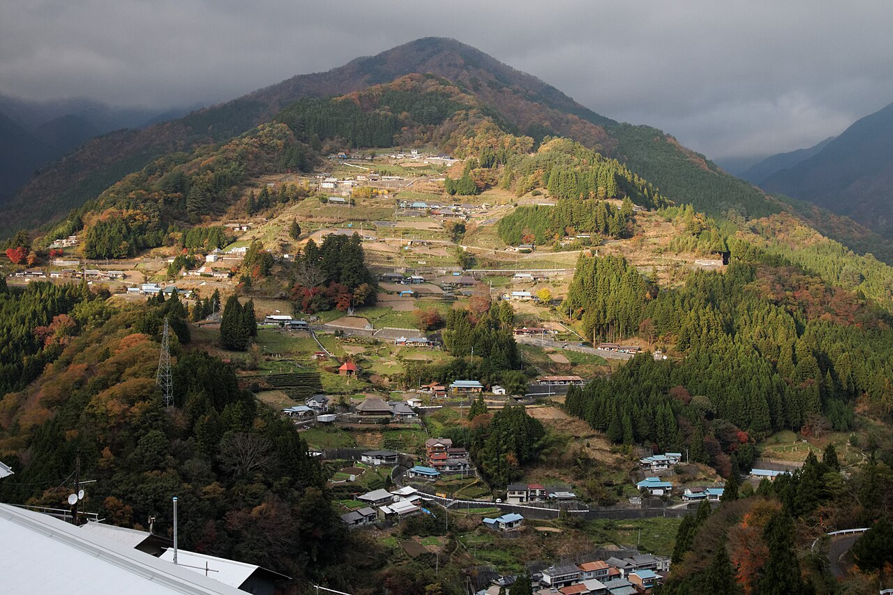 Houses and terraced fields spread across a steep mountainside at Ochiai village in Higashi-Iya, Tokushima